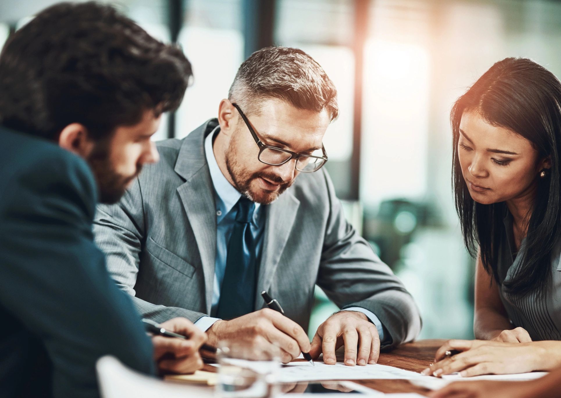 Business owners reviewing financial records with an advisor